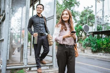 Business man and woman walking trough sidewalk smiling going to office