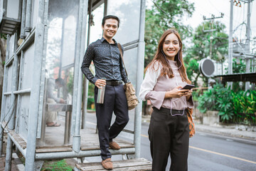 Business man and woman walking trough sidewalk smiling going to office