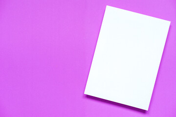 Obraz na płótnie Canvas top view of blank white A4 paper with shadow on blank purple paper background, flat lay.