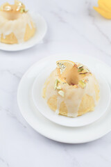 Lemon cake with sugar frosting on marble table. Healthy dessert. Delicious breakfast, traditional tea time treat. Modern summer food minimal concept, copy space