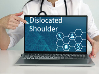  Dislocated Shoulder text in list. Neurologist looking for something at laptop.