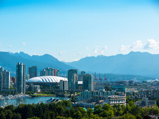 Skyline of the city of Vancouver with Canadian Rocky Mountains to rear of image