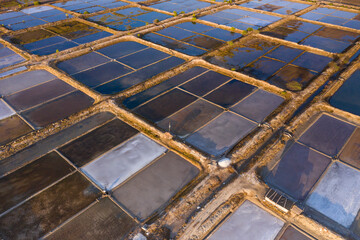 Abstract aerial drone view showing details of salt fields parcels and located on the northern coast of Bali in Indonesia.