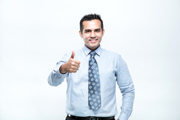 An Asian working man in an office suit is stands with a happy face and a commitment to work, giving thumb against on white background.