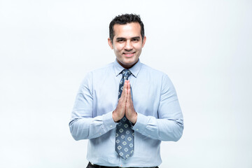 An Asian working man in an office suit standing, hello, greeting with a smiley face, on white background.