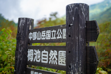 秋の紅葉が始まった長野県北安曇郡小谷村の栂池自然園の展望台までトレッキングしている風景 A view of trekking to the observatory of Tsugaike Nature Park in Otari Village, Kita-Azumi-gun, Nagano Prefecture, where the autumn leaves have begun to cha