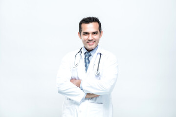 Portrait of cheerful smiling man doctor with arms crossed on white background.