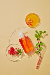 Cosmetic bottle containers with pomegranate and pomegrante seeds extract and scientific glassware. Blank label package for branding mock-up. Research and develop natural organic beauty skincare. 