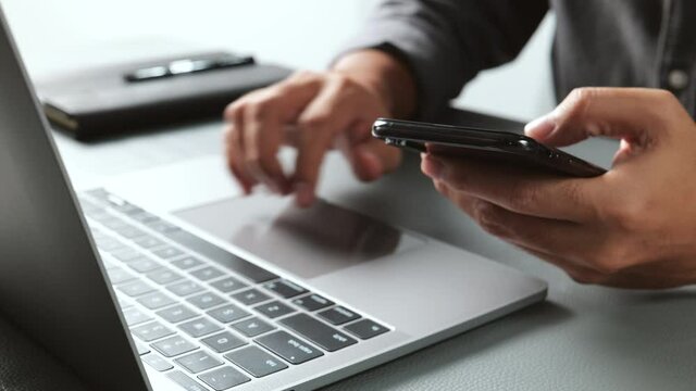 Businessman working with devices. Student using laptop computer and mobile smartphone, business concept