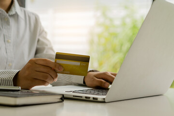 woman holding credit card and using laptop to work business people or entrepreneurs working, online shopping, ecommerce, concept internet banking, money spending, taxes