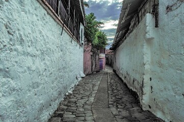 narrow street in old port city with stone floor