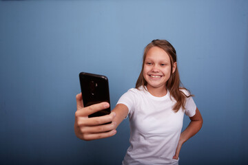 Fototapeta premium a beautiful girl of 11 years old takes a selfie