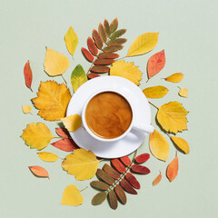 Fototapeta na wymiar Autumn composition with cup of coffee and autumn leaves. Cozy atmosphere and hot coffee with milk