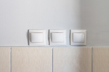 Three switches for turning on and off the lighting on the wall