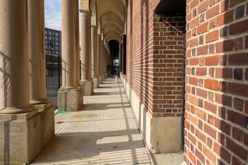 Outdoor corridor pathway with arched columns. 