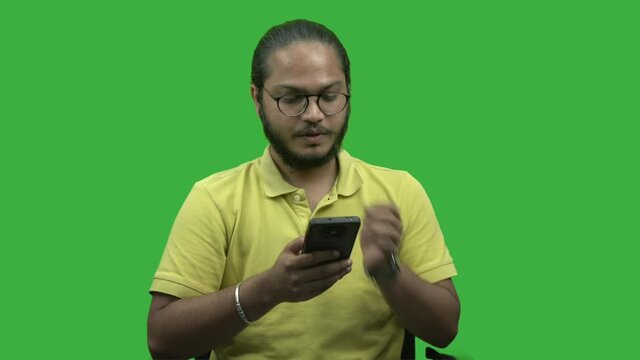Vivek with aspects  man-boy with long hairs talking on phone croma background