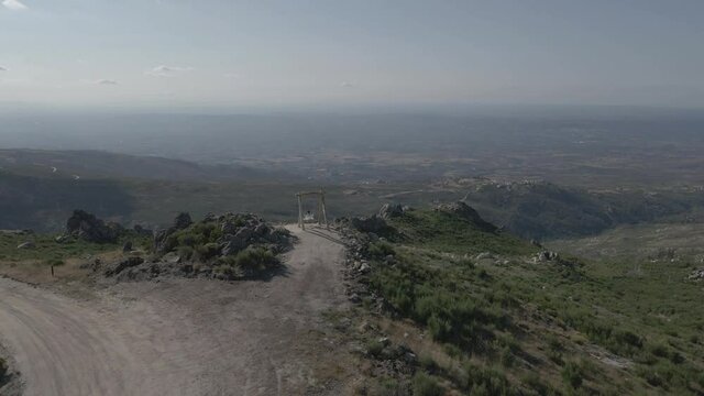 Drone pushes over Farao Swing with a woman in white clothes swinging in the wind.