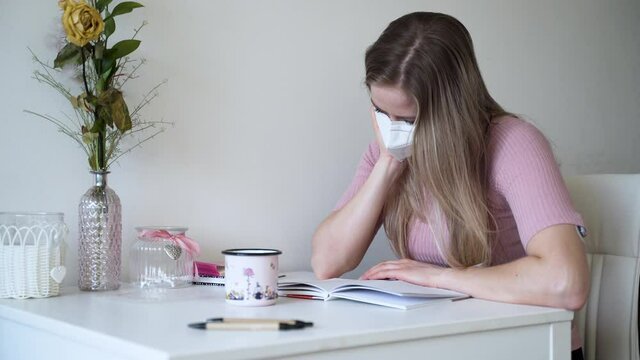 A young girl reads a letter from her lover in her apartment. Distance relationship.