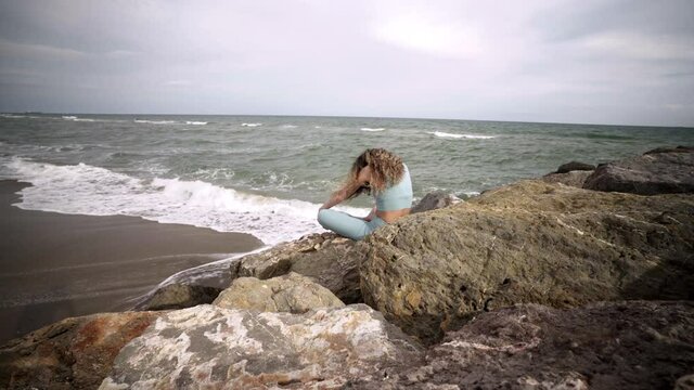 Spiritual stretching for body flexibility by yogi at Bogatell beach