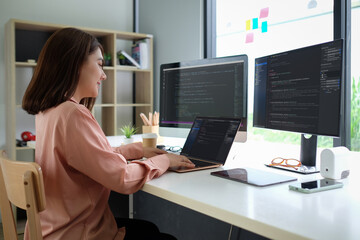 Fototapeta na wymiar Asian female programmer working at at modern office. Developing programming..