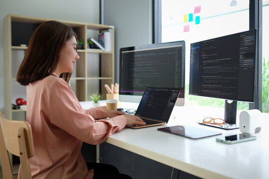 Asian female programmer working at at modern office. Developing programming..