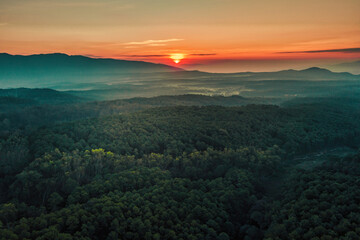 Fototapeta na wymiar Aerial view of sunrise over mountian and pine tree in Chiang Mai Province, Thailand.