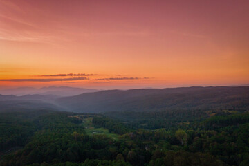 Aerial view of sunrise over mountian and pine tree in Chiang Mai Province, Thailand.