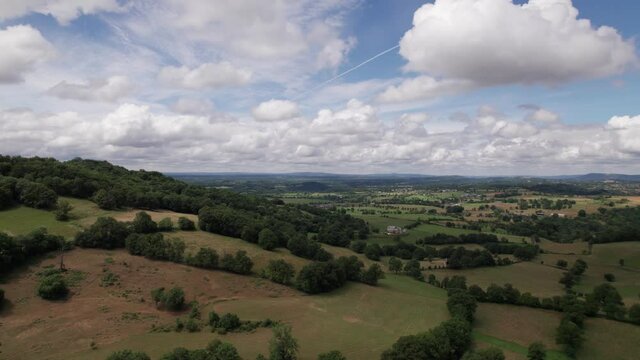 Amazing aerial view of french countryside. Beautiful drone view of farmlands and fields. Agriculture, rural landscape with blue sky and clouds