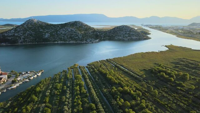 Delta river Neretva, a protected nature reserve with fertile soil good for growing fruit trees in Croatia in summer sunset