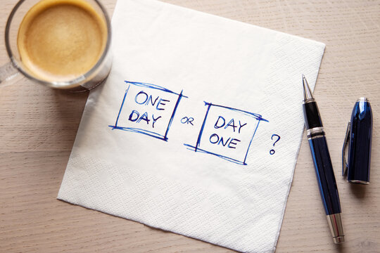 One Day or Day One? Motivational quote hand written on the napkin