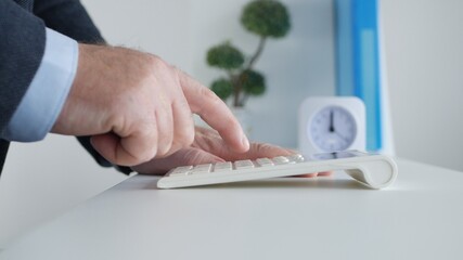 Businessman Working with Invoices, Makes Financial Calculations with Adding Machine. Accounting Fee and Taxes Calculations.