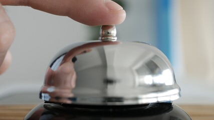 Tourist in Hotel Reception Presses the Bell Button Calling the Receptionist