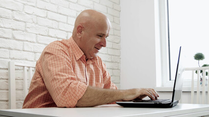 Image with a Businessman in Office Room Using a Laptop and Smiling Happy