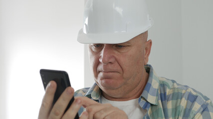 Upset Engineer Texting on Mobile Phone. Constructor Sending and Receiving Emails on Cellphone.