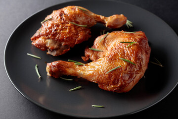 Grilled chicken drumsticks sprinkled with rosemary.