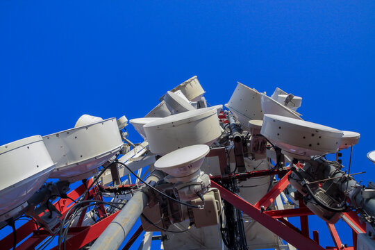 telecommunications tower of different mobile phone, radio and television operators with masts and microwave radio link antennas, 4g and deployment of 5g generation in cities and rural areas 