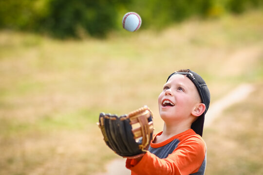 A Happy child with baseball ball on nature concept in park