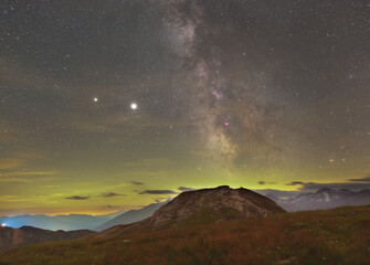 Milky Way over Alps with Jupiter, Saturn and magenta nebulaes