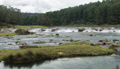 beautiful and scenic view of pykara waterfalls and pykara river, the river is flowing through green...