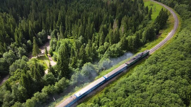 old diesel train moving along the railway lane beautiful scenery forest mountains