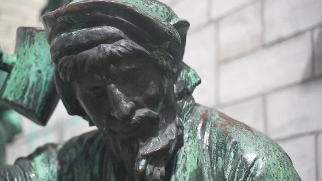 Close up of the face of the Stonemason and his hammer from the iconic sculpture &ldquo;the Builders&rdquo; outside the Cathedral of Our Lady. An art piece which remember those who built it, Antwerp, Belgium