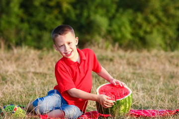 A Happy child eating watermelon concept in nature in the park