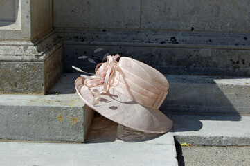 Lady's hat resting on church step, wedding still life - 457467218