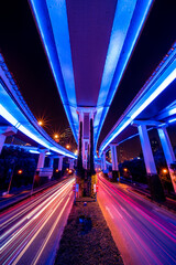 Abstract cityscape traffic with motion blur. Moving through modern city street with neon...