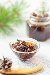Young mini pine cones jam in jar. Healthy and tasty dessert