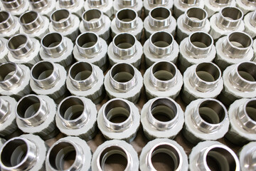 many metal pipe couplings in a pipe factory