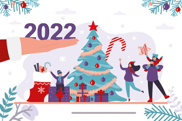 Santa Claus hand gives 2022 year numbers. Happy family near traditional xmas tree, christmas celebration. New year, winter holidays, horizontal banner.