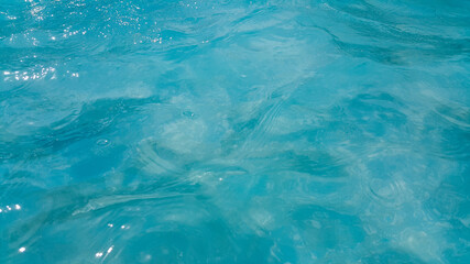 The swaying water surface of the sea. The concept of recreation. Oceanic background. Sparkling seawater. Tourist destination on the sea. Peace and tranquility. Anti-stress photography.