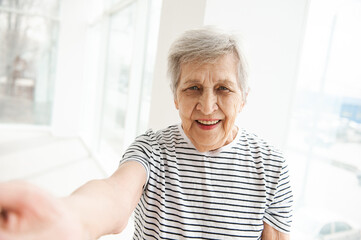 A beautiful elderly woman is talking on a video link.