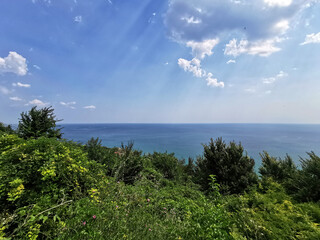 The blue sea seen from a green hill